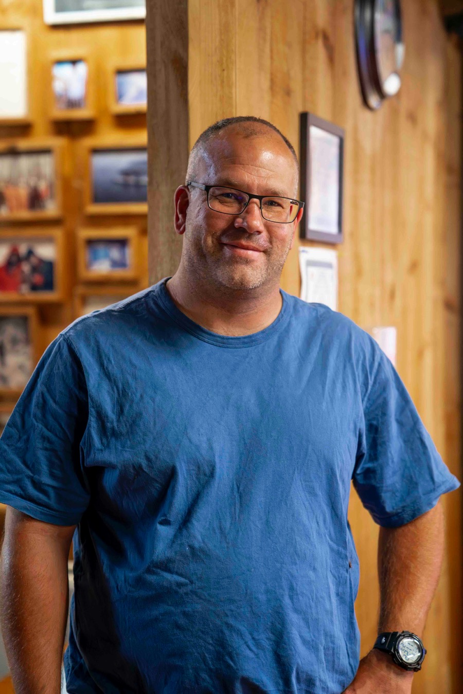 Man with glasses smiling at home